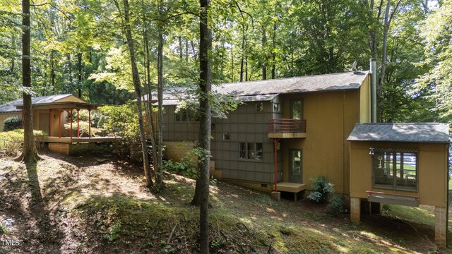 rear view of house featuring a gazebo and a balcony