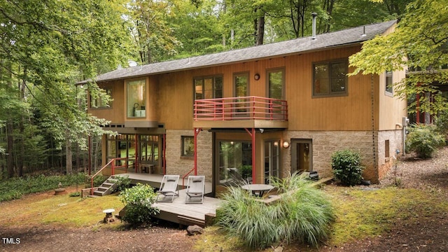 rear view of house with a wooden deck