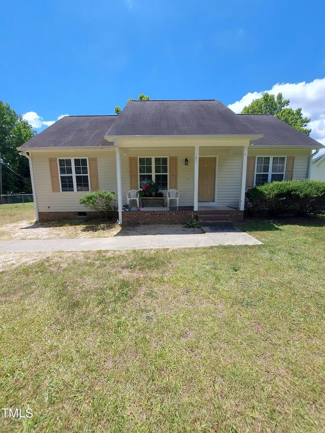 single story home featuring a porch and a front lawn