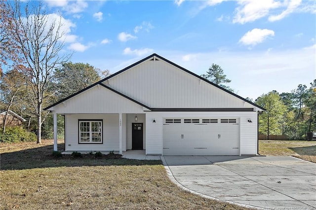 view of front of house featuring a garage and a front lawn