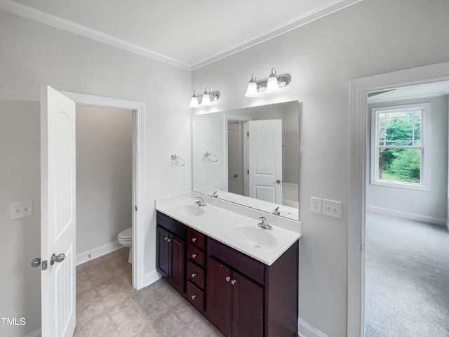 bathroom with crown molding, vanity, and toilet