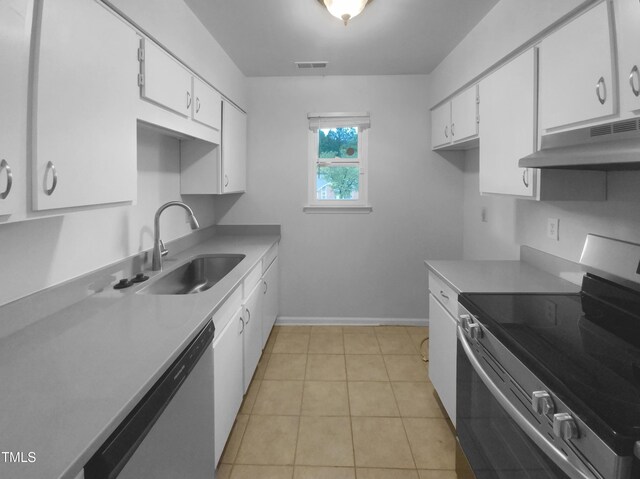 kitchen featuring white cabinets, sink, stainless steel appliances, and light tile patterned floors