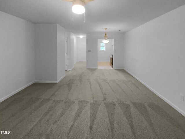 interior space featuring ceiling fan and light colored carpet