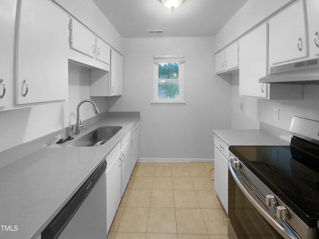 kitchen with white cabinetry, stainless steel appliances, sink, and light tile patterned floors