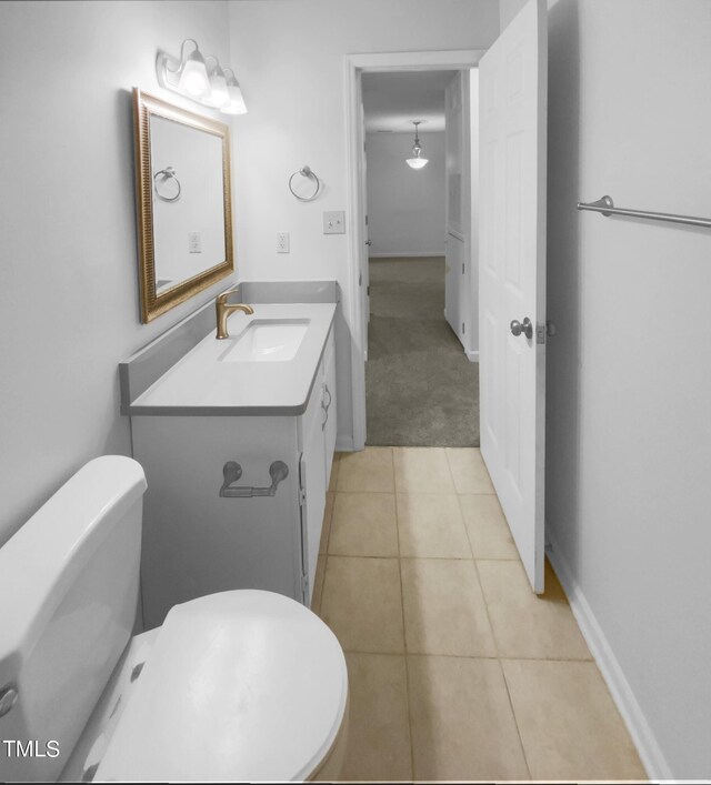 bathroom featuring tile patterned floors, vanity, and toilet