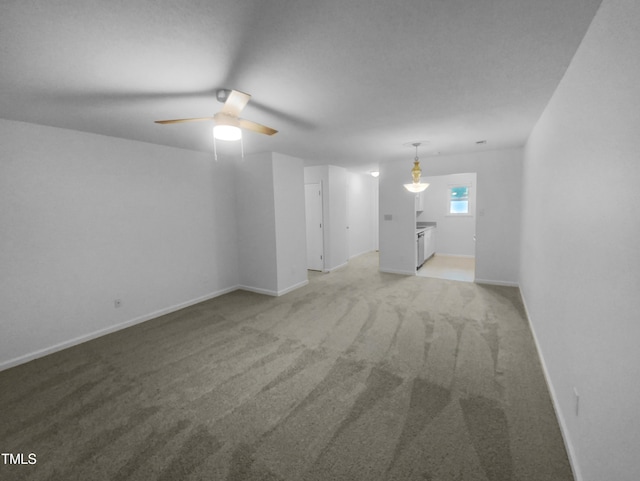 interior space featuring ceiling fan and light colored carpet