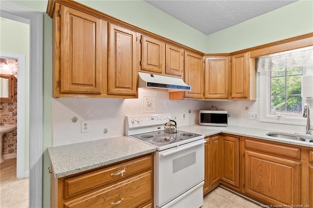 kitchen with light stone counters, tasteful backsplash, sink, white range with electric cooktop, and a textured ceiling