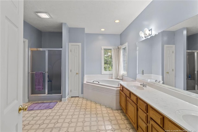 bathroom featuring vanity and independent shower and bath