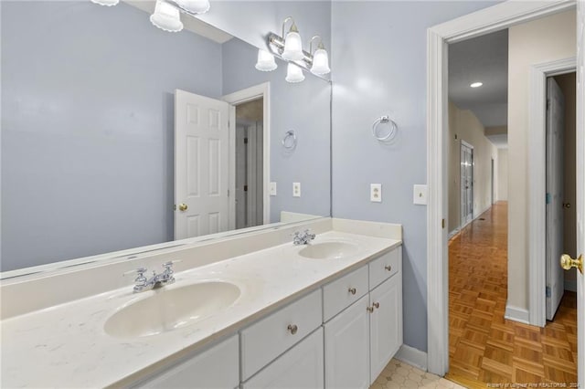 bathroom with vanity and parquet flooring