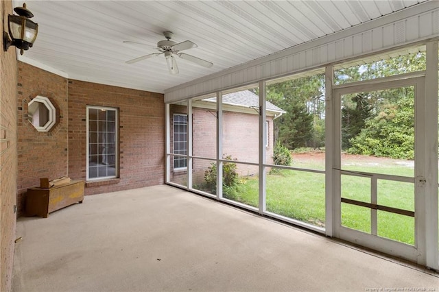 unfurnished sunroom featuring ceiling fan