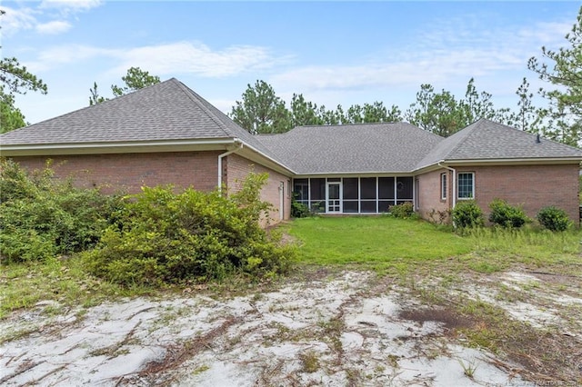 back of house with a yard and a sunroom