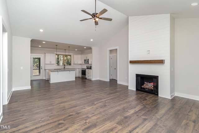 unfurnished living room featuring dark wood-type flooring, ceiling fan, a fireplace, and high vaulted ceiling