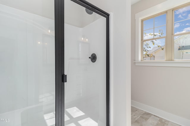 bathroom with a shower with door