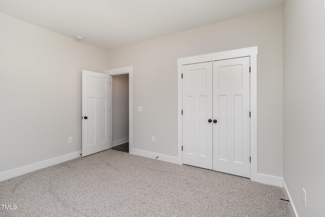 unfurnished bedroom with carpet floors and a closet