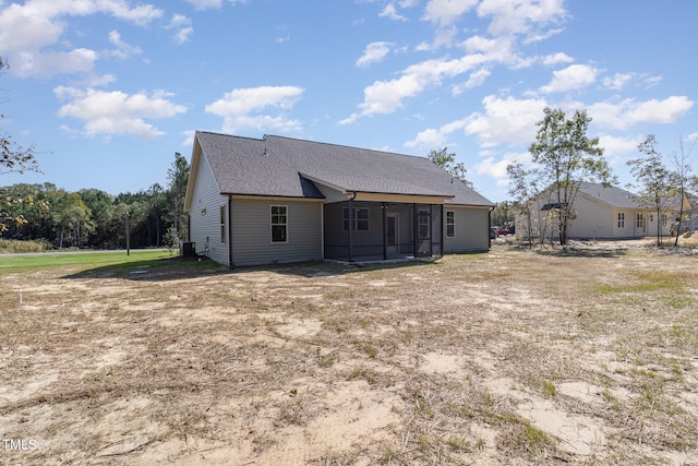 rear view of house with a sunroom and central air condition unit