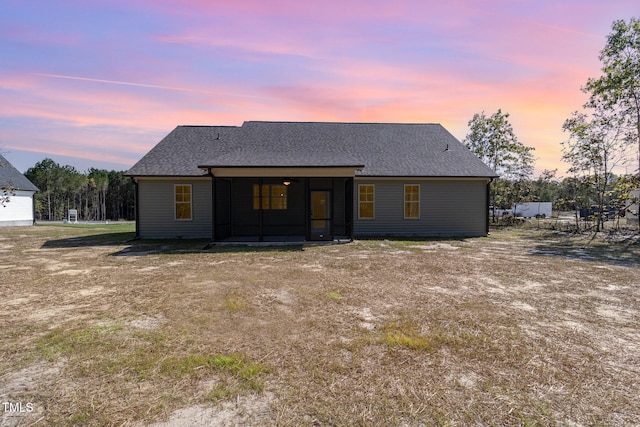 view of back house at dusk