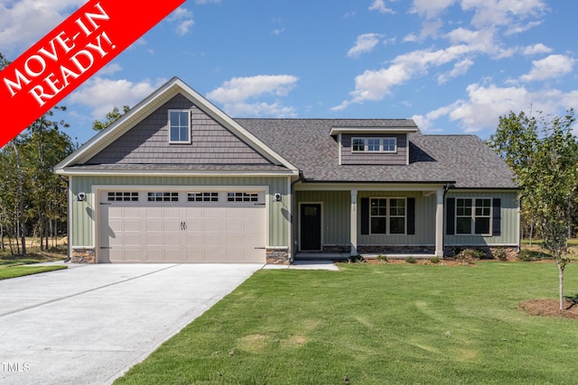 craftsman house featuring a front lawn and a garage