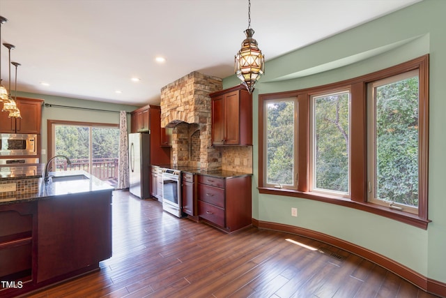 3240 Hillcastle Trl, Chapel Hill, NC 27516 - kitchen with stainless steel appliances, tasteful backsplash, dark wood-style floors, a chandelier, and decorative light fixtures