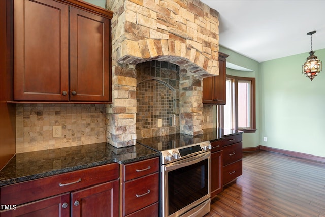 kitchen featuring electric stove, dark stone countertops, tasteful backsplash, decorative light fixtures, and dark hardwood / wood-style flooring