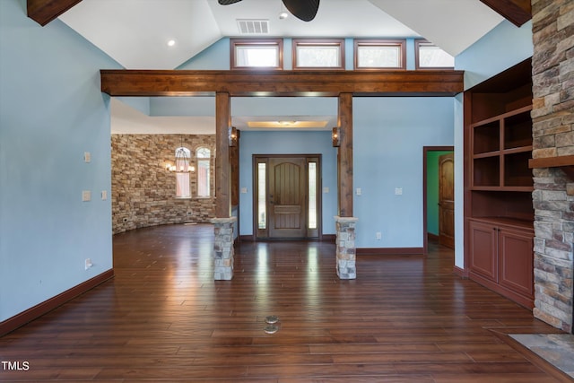 unfurnished living room featuring ceiling fan with notable chandelier, dark hardwood / wood-style flooring, and high vaulted ceiling