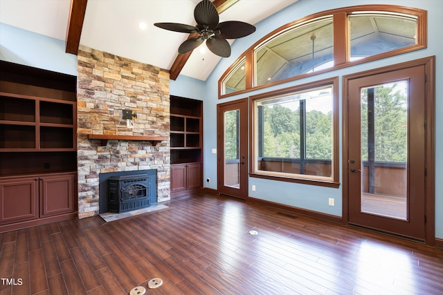 unfurnished living room with beam ceiling, a wood stove, and dark wood-type flooring