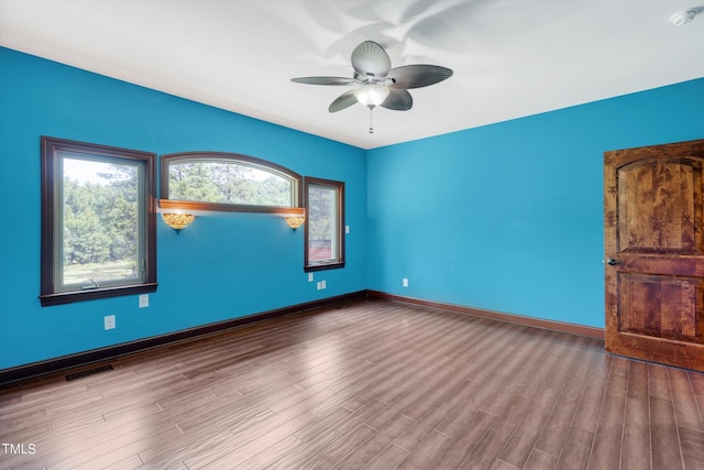 empty room with ceiling fan and light wood-type flooring