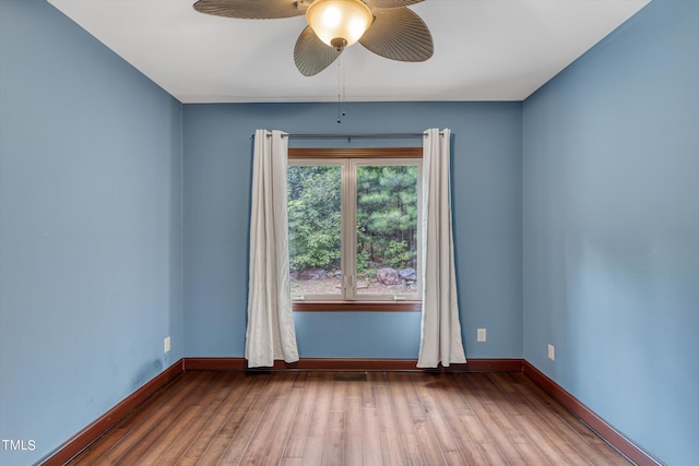 unfurnished room with ceiling fan and hardwood / wood-style flooring