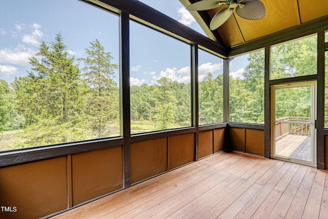 unfurnished sunroom featuring ceiling fan and plenty of natural light