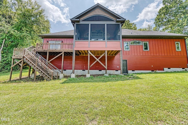 rear view of house featuring a sunroom, a yard, and a wooden deck