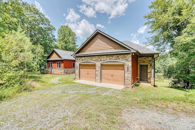 view of front of house featuring a garage and a front lawn