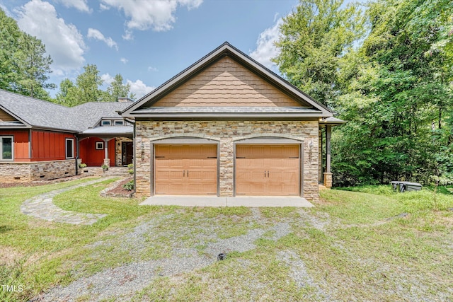 view of front of property featuring a garage and a front lawn