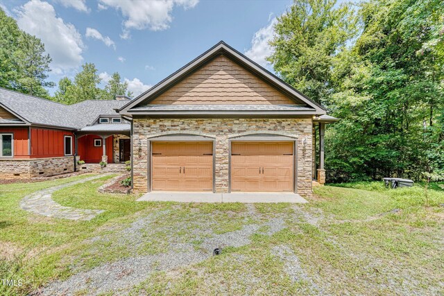 3240 Hillcastle Trl, Chapel Hill, NC 27516 - view of front of house with stone siding, a front lawn, driveway, and an attached garage
