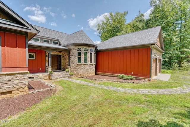 3240 Hillcastle Trl, Chapel Hill, NC 27516 - view of front of property with board and batten siding, stone siding, a front lawn, and roof with shingles