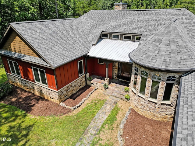 3240 Hillcastle Trl, Chapel Hill, NC 27516 - view of front of property featuring stone siding, a chimney, roof with shingles, and board and batten siding