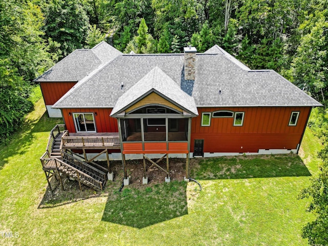 3240 Hillcastle Trl, Chapel Hill, NC 27516 - back of property with a shingled roof, a sunroom, a deck, stairs, and a lawn
