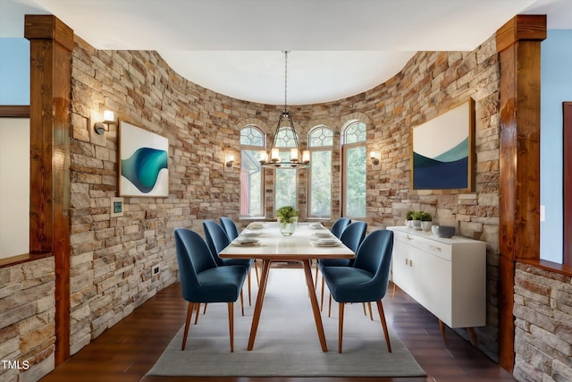 dining area featuring a notable chandelier and dark hardwood / wood-style floors