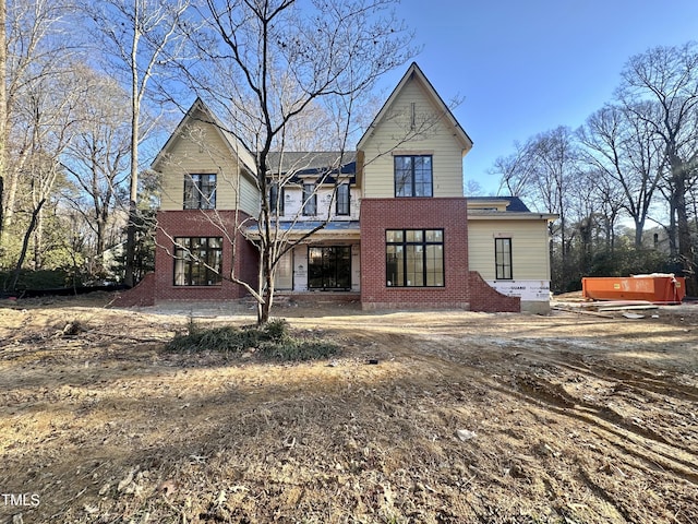 back of property with a hot tub