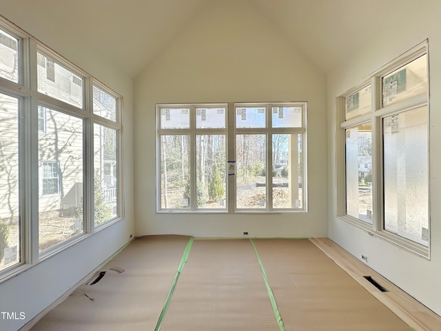 unfurnished sunroom featuring visible vents and vaulted ceiling