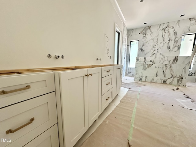 full bathroom featuring a marble finish shower