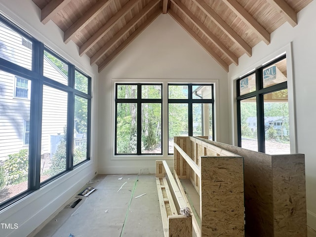 unfurnished sunroom featuring beam ceiling