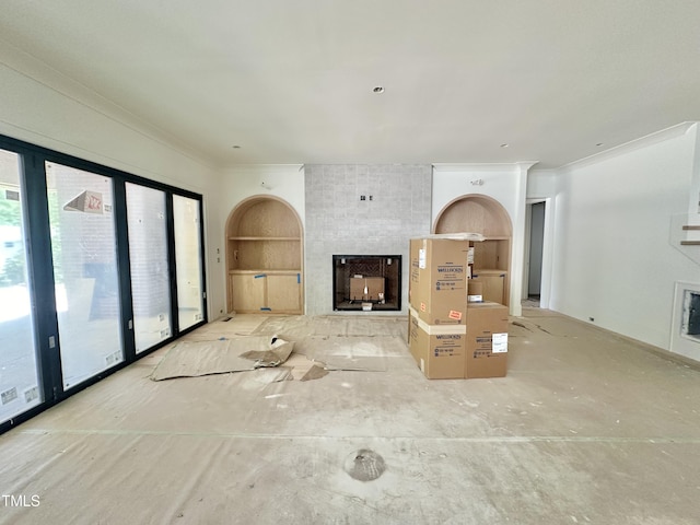 unfurnished living room featuring built in shelves, crown molding, and a multi sided fireplace