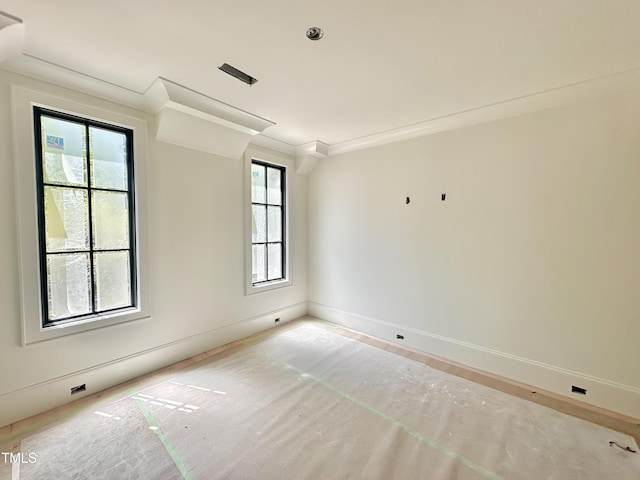 unfurnished room with baseboards and ornamental molding