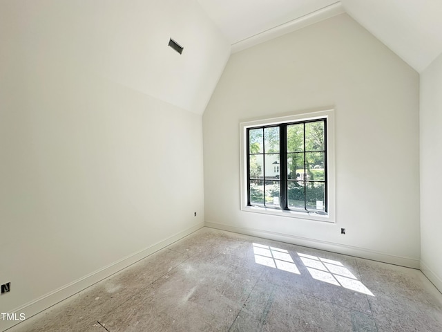 interior space with vaulted ceiling and baseboards