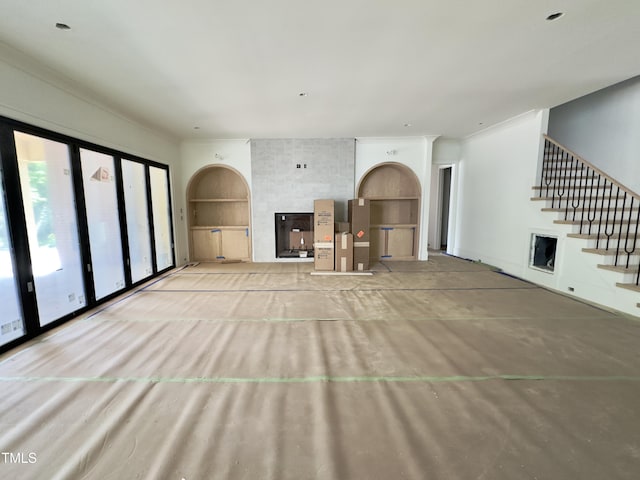 7208 Tanbark Way, Raleigh, NC 27615 - unfurnished living room featuring stairs and built in shelves