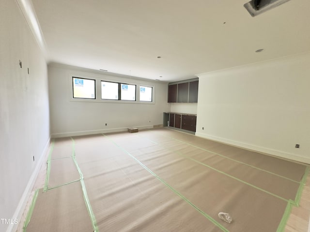 7208 Tanbark Way, Raleigh, NC 27615 - unfurnished living room featuring baseboards and crown molding