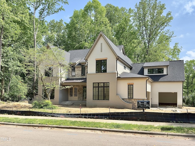 7208 Tanbark Way, Raleigh, NC 27615 - modern farmhouse style home featuring roof with shingles, fence, and stone siding