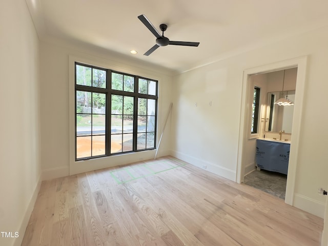7208 Tanbark Way, Raleigh, NC 27615 - spare room with wood finished floors, a ceiling fan, and baseboards