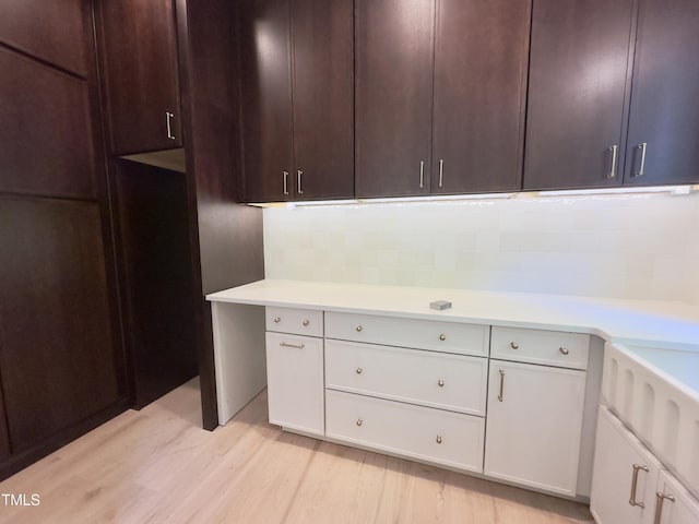 7208 Tanbark Way, Raleigh, NC 27615 - kitchen with light countertops, light wood-style flooring, dark brown cabinetry, and white cabinetry