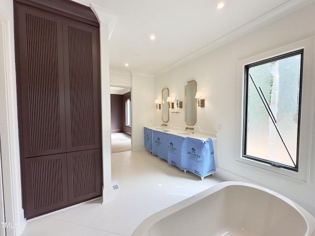 7208 Tanbark Way, Raleigh, NC 27615 - full bathroom with a freestanding tub, double vanity, recessed lighting, and ornamental molding