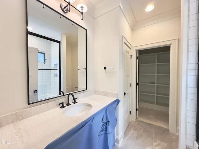 7208 Tanbark Way, Raleigh, NC 27615 - bathroom with vanity, a spacious closet, and an enclosed shower
